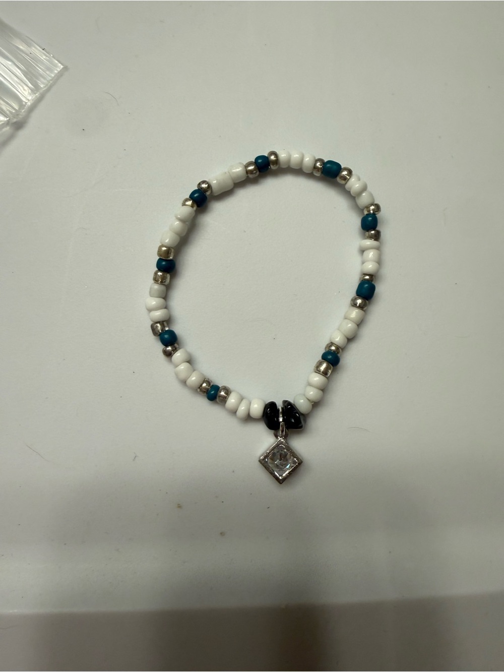 Beaded White and Teal Bracelet with Silver Charm